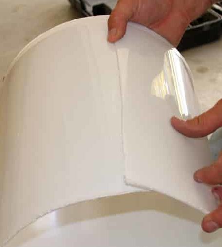 White bucket on its side showing overlap larger at the bottom than the top.